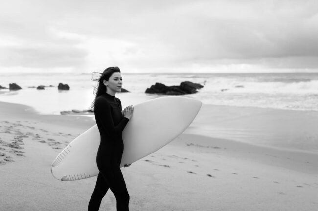 11. young-beautiful-woman-with-surfboard-walking-on-be-2023-02-21-03-49-06-utc