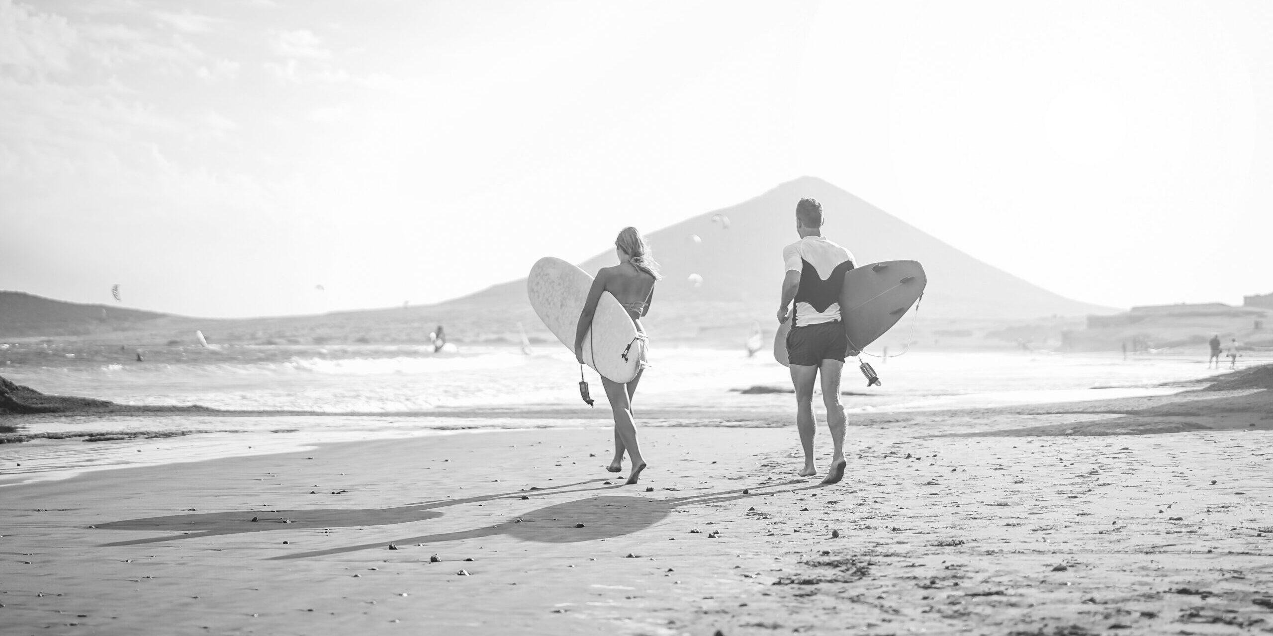 12. happy-surfers-running-with-surfboards-on-the-beach-2021-09-04-02-21-10-utc