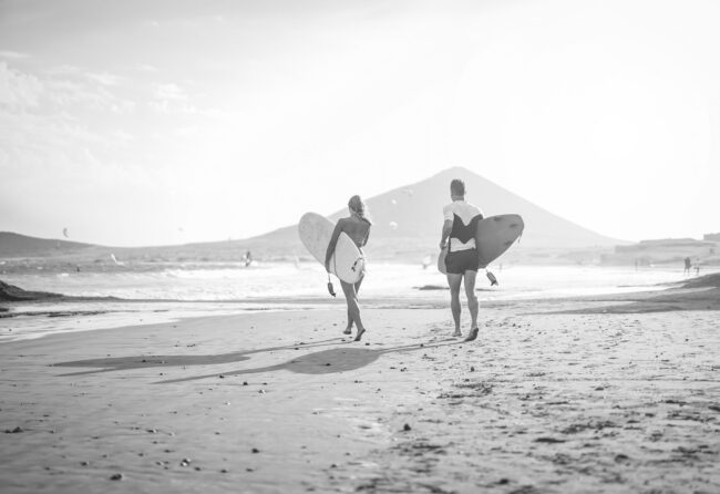 12. happy-surfers-running-with-surfboards-on-the-beach-2021-09-04-02-21-10-utc
