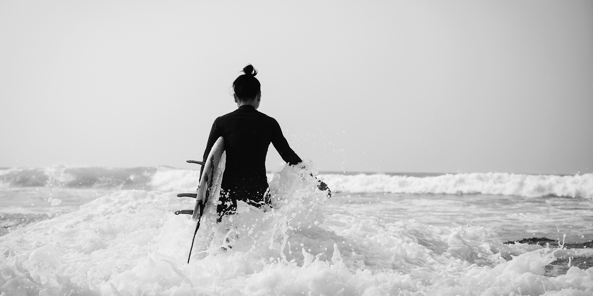 surfer-with-surfboard-in-the-waves-2024-12-06-12-46-50-utc